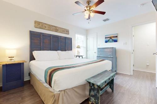 a bedroom with a large bed and a ceiling fan at South Pearl Sailfish in Rockport