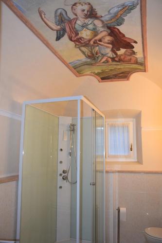 a bathroom with a shower and a painting on the ceiling at Casa del Drago in Sulzano