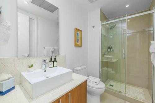 a bathroom with a sink and a shower and a toilet at Apartment in paradise on the happy island of ARUBA, beachfront in Savaneta