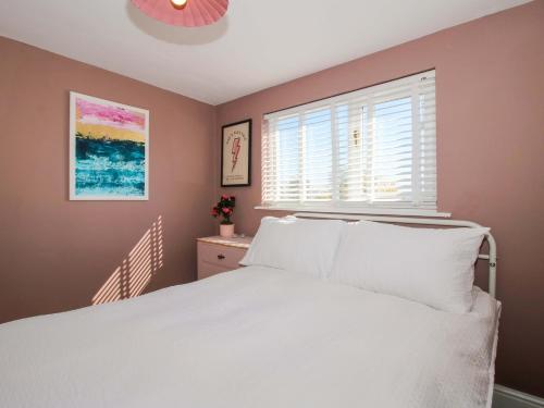 a bedroom with a white bed and a window at Cheshire Views in Malpas