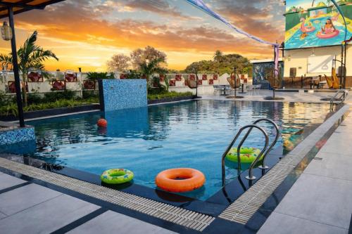 a pool at a resort with an orange ball in the water at IR Resorts Mahasamund in Mahāsamund