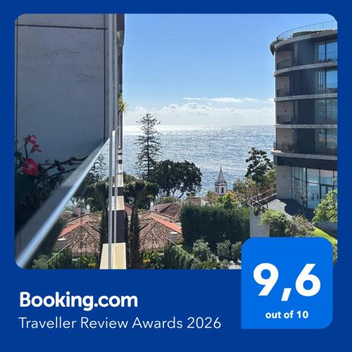 a view of the ocean from a balcony of a building at Astro Madeira Apartments in Funchal