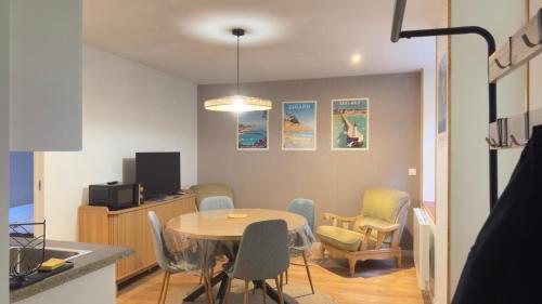 a kitchen and dining room with a table and chairs at KENDALL in Saint Malo