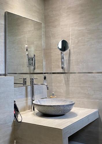 a bathroom with a large stone sink on a counter at Résidence Petru-Maria in Propriano