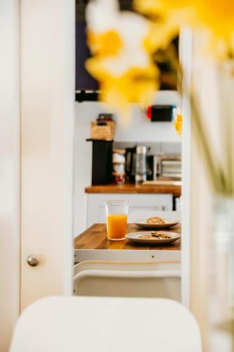 a kitchen with a table with a glass of orange juice at Robyns Retreat in Brynsiencyn