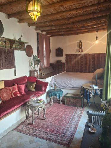 a living room with a bed and a couch at Dar Tiziri in Sousse