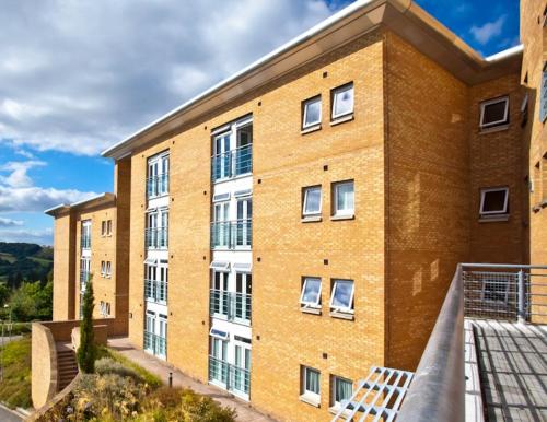 an apartment building with a balcony in front of it at University of Exeter - Holland Hall in Exeter
