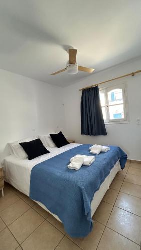 a bedroom with a large bed with towels on it at Blue House Naxos in Naxos Chora
