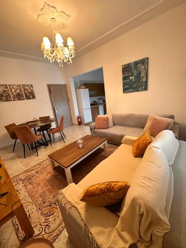 a living room with a couch and a table at Dryrivers house in Xiropótamos