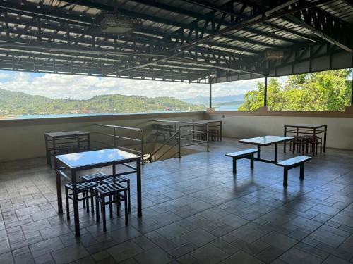 a room with tables and chairs and a large window at RTRoss Hotel in Masbate