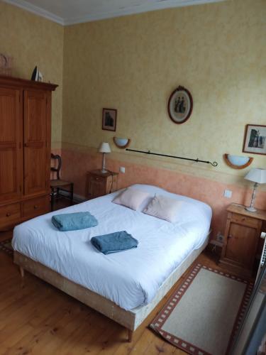 a bedroom with a bed with two towels on it at maison entière in Fécamp