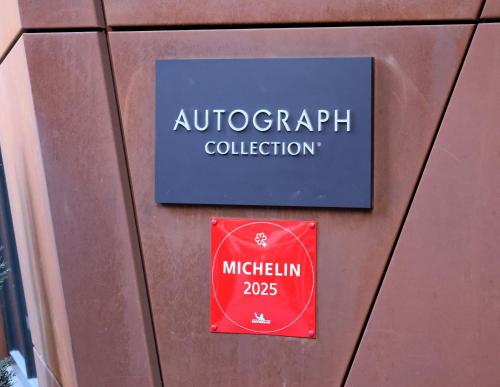 a sign for a university of autograph collection on a wall at The Dorian, Autograph Collection in Calgary