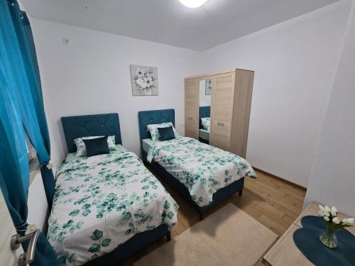 a bedroom with two beds and a mirror at Apartment Angel in Kotor