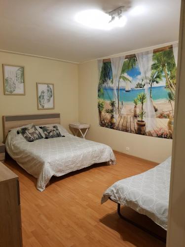 a bedroom with two beds and a painting on the wall at Casino in Dieppe
