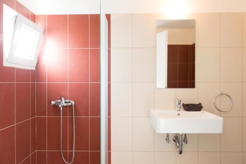 a bathroom with a sink and a shower at Aerides Boutique Rooms in Vathi