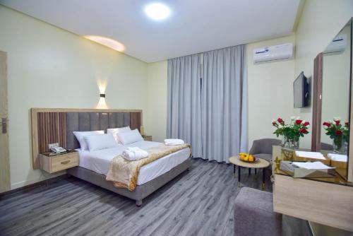 a hotel room with a bed and a living room at Hôtel Atlas in Tangier