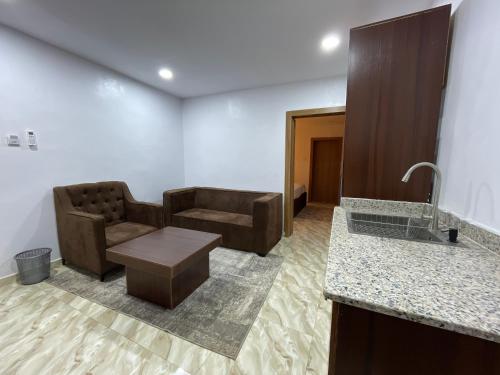 a living room with a couch and a table at House 2 Guest House - Felele in Ibadan