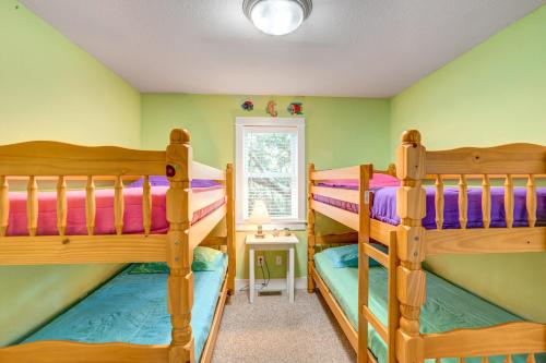 two bunk beds in a room with green walls at The Nauti Flyer in Corolla