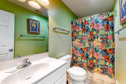 a bathroom with a sink and a shower curtain at The Nauti Flyer in Corolla