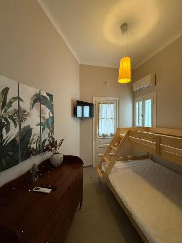 a bedroom with a large bed with a wooden frame at The Garden House in Tinos