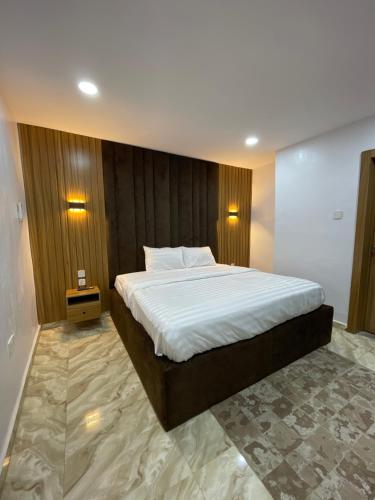 a bedroom with a large bed in a room at House 2 Guest House - Felele in Ibadan
