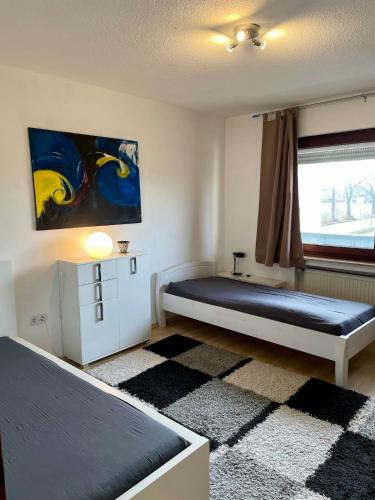 a bedroom with two beds and a painting on the wall at Haus in Kamen Nähe Sportschule in Kamen