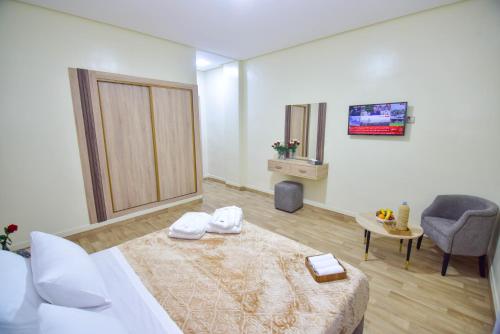 a hotel room with a bed and a chair at Hôtel Atlas in Tangier