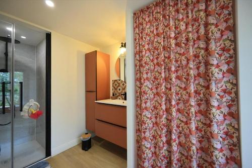 a bathroom with a shower curtain in a room at Bégous in Valderiès