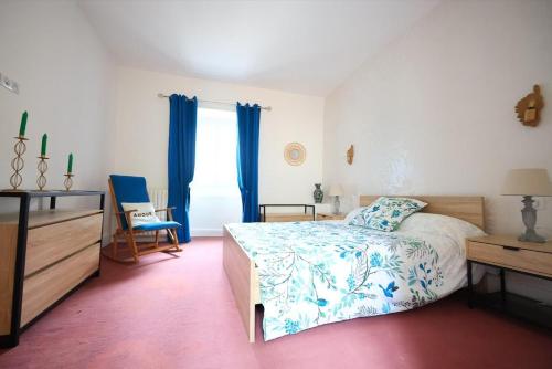a bedroom with a bed and a dresser and a window at Bégous in Valderiès