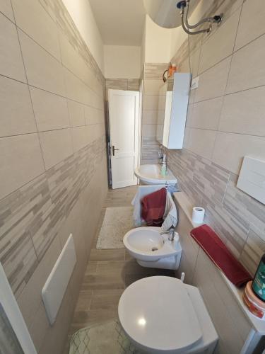 a bathroom with a toilet and a sink at Piazzetta 293 in Rosolina Mare