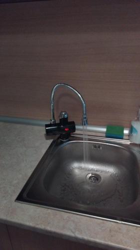 a kitchen sink with water coming out of a faucet at Sasha Yo in Razlog