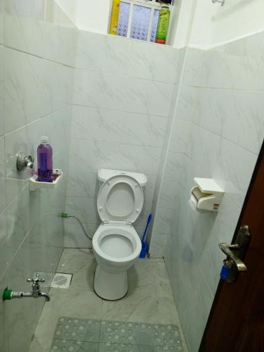 a bathroom with a white toilet in a stall at Wema m stays in Munyu