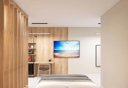 a bedroom with a bed and a tv on a wall at KIBO Boutique in Frumuşani