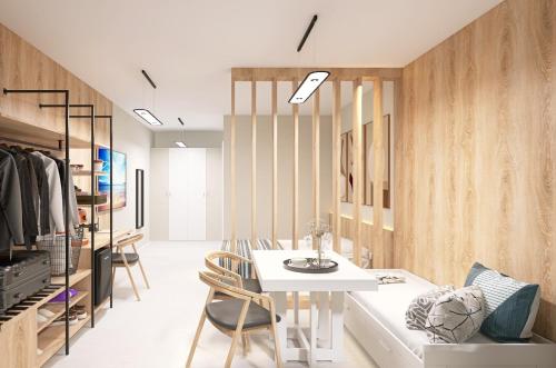 a living room with a white table and chairs at KIBO Boutique in Frumuşani