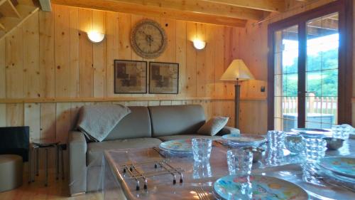 a living room with a couch and a table at Cabanes flottantes et gîtes au fil de l'eau in Colleville