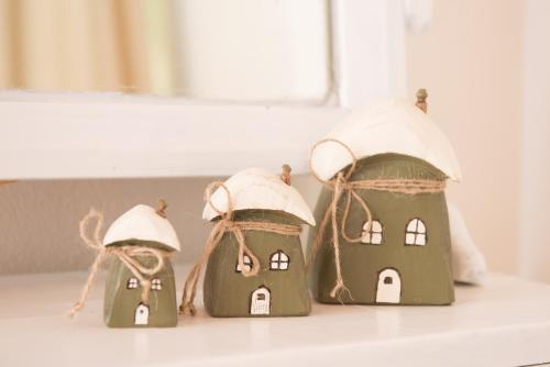 three small gingerbread houses sitting on a window sill at Aerides Boutique Rooms in Vathi