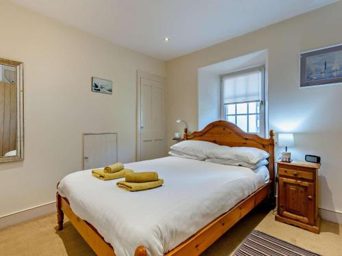 a bedroom with a large bed with towels on it at 2 Bed in Aberdyfi oc-dy015 in Aberdyfi