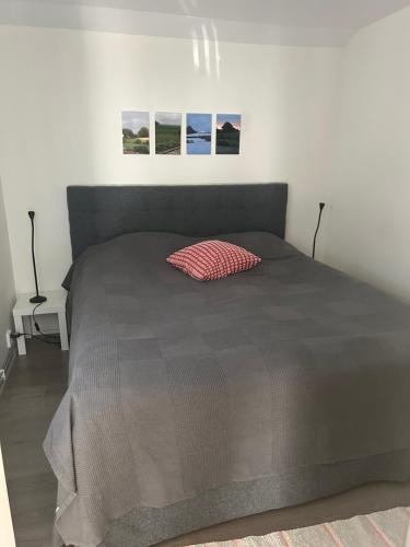 a bed with a brown comforter in a bedroom at Tunneberga 1 65 in Jonstorp