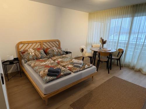a bedroom with a bed with a table and a dining room at AuszeitOase inkl Oberstaufen Plus Karte in Oberstaufen