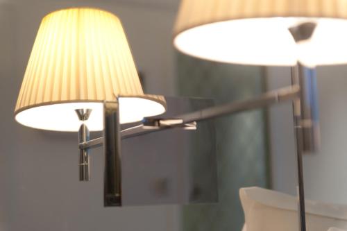 a pair of lamps sitting next to a mirror at Le César Hôtel in Provins
