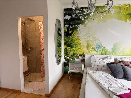 a bathroom with a chandelier and a couch with a shower at Apartments Let Me In in Pörtschach am Wörthersee
