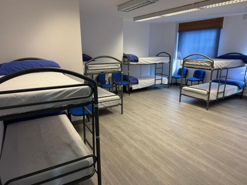 a group of bunk beds in a room at Albergue el cristo in Porriño