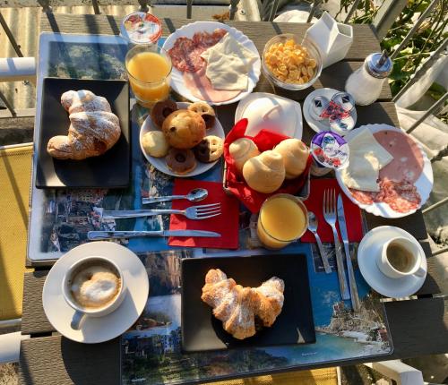 a table topped with plates of food and cups of coffee at 88 Miglia in La Spezia