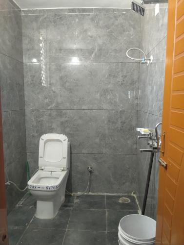 a small bathroom with a toilet and a sink at Leisure Paradise in Kharar
