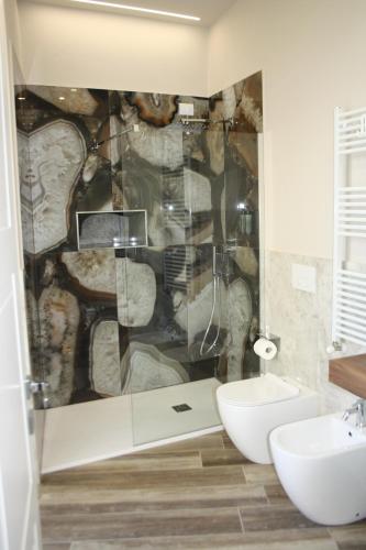 a bathroom with a shower with a toilet and a sink at Palazzo Partenope in San Severo