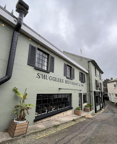 a building with a sign on the side of it at Smugglers Hotel in Brixham