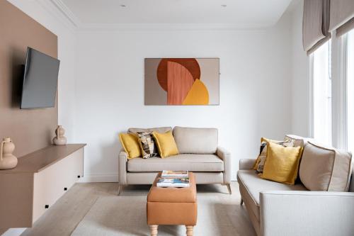 a living room with two couches and a coffee table at The Jubilee by Supercity Aparthotels in Leeds
