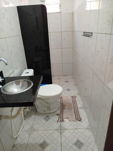 a bathroom with a toilet and a sink at pousada chykos in Barreirinhas