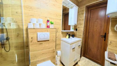 a bathroom with a toilet and a sink at Koliba Buba in Brčko
