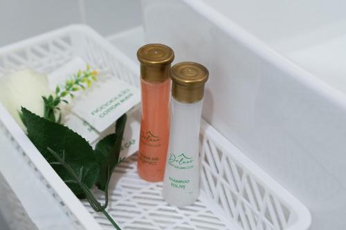 two bottles ofodorizers are sitting in a drawer at Deluxe Hotel Chaiyaphum in Chaiyaphum